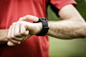 A man checks his watch as he wonders how long do the effects of oxycontin last