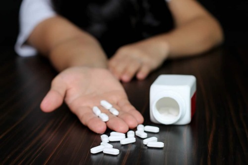 white pills spilled on table showing the long term side effects of xanax