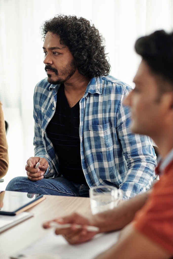 Man sitting in group therapy session during adderall rehab