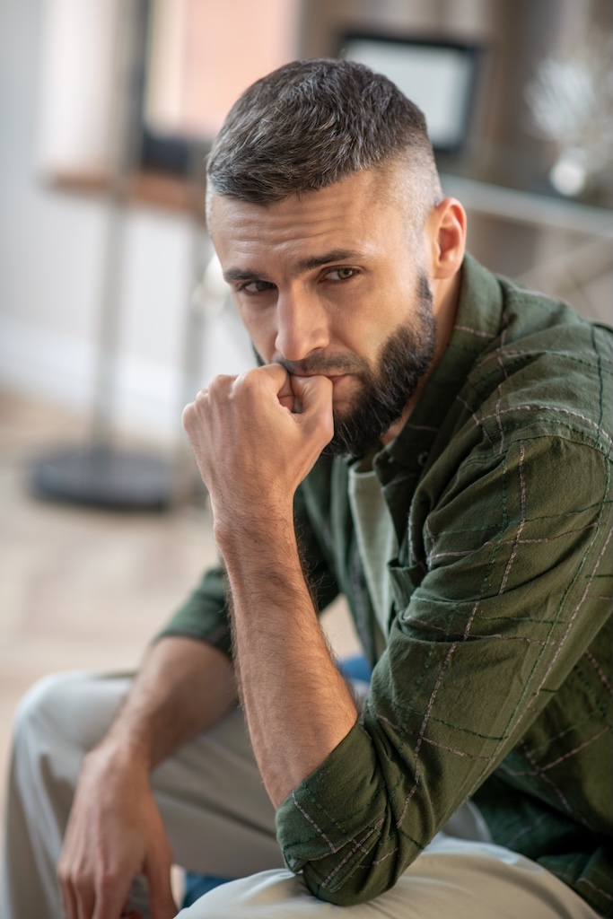 Dark-haired bearded man feeling stressful