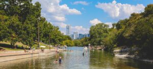 Photo of people swimming and paddle boarding at barton creek