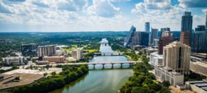 An aerial view of downtown Austin with modern buildings along the riverbank. Texas, USA. Cropped.