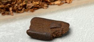 piece of afghan hash isolated on white background close up