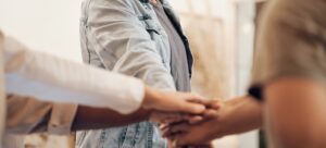 Man, group and hands together for teamwork, support and trust with friends, community or people