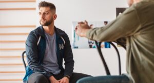 Young man with addiction in a psychotherapy