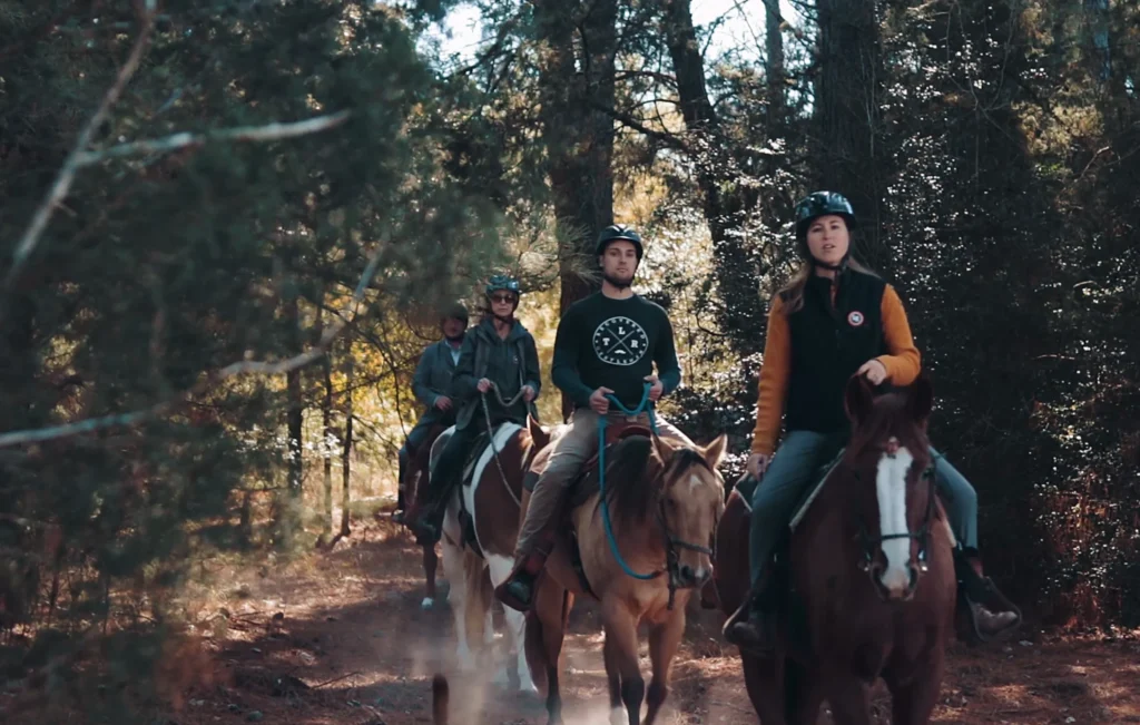 Staff members at The Last Resort Recovery participating in equine therapy, riding horses alongside clients.