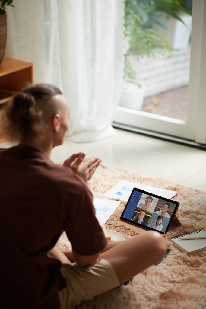 Young man actively gesturing when explaining challenges in online group therapy session